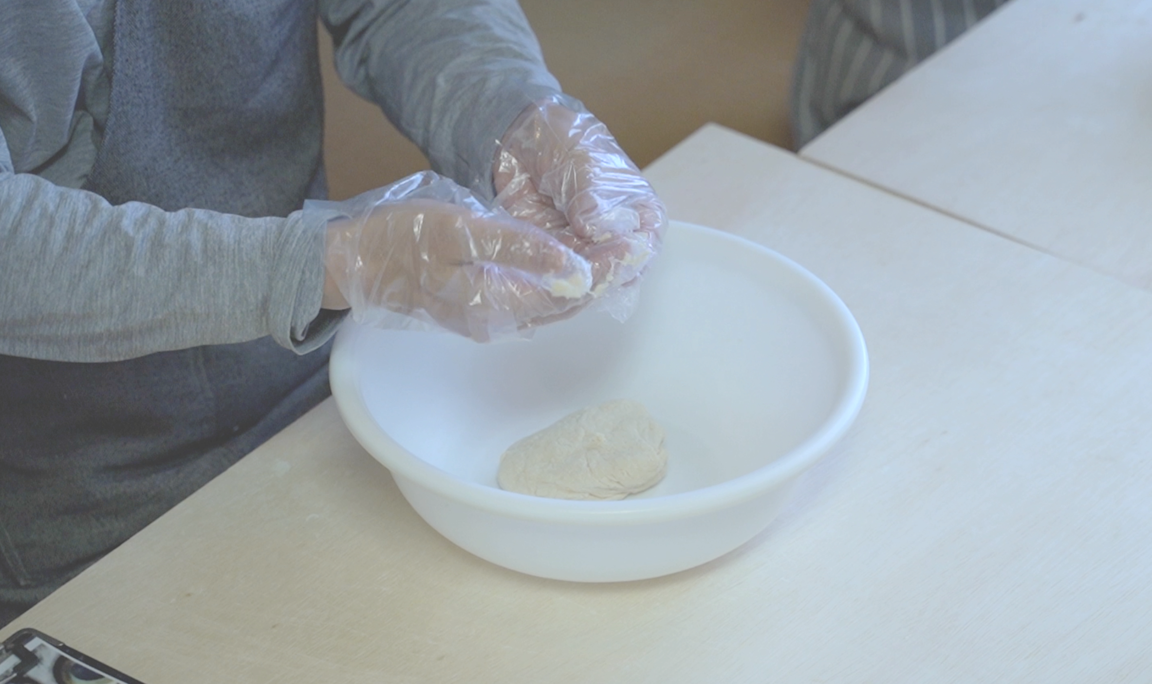 Kneading hōtō dough in a bowl