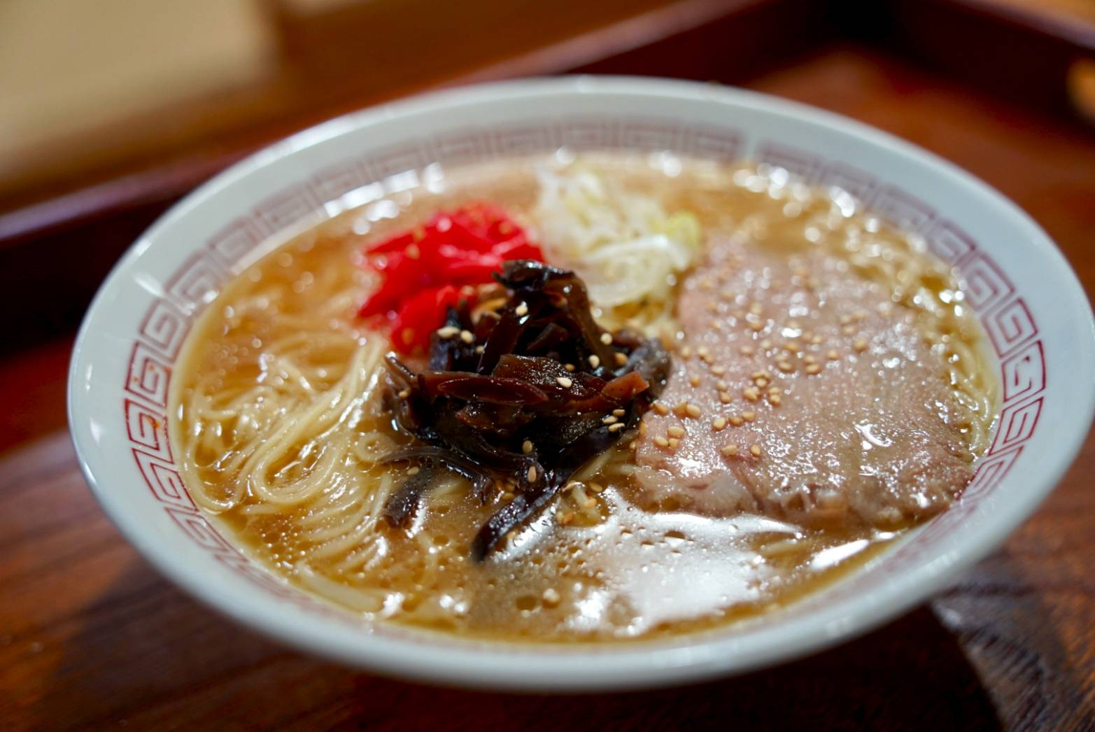 A bowl of hand-made ramen noodles in rich tonkotsu broth