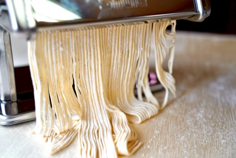 Feeding ramen dough through the noodle cutting machine
